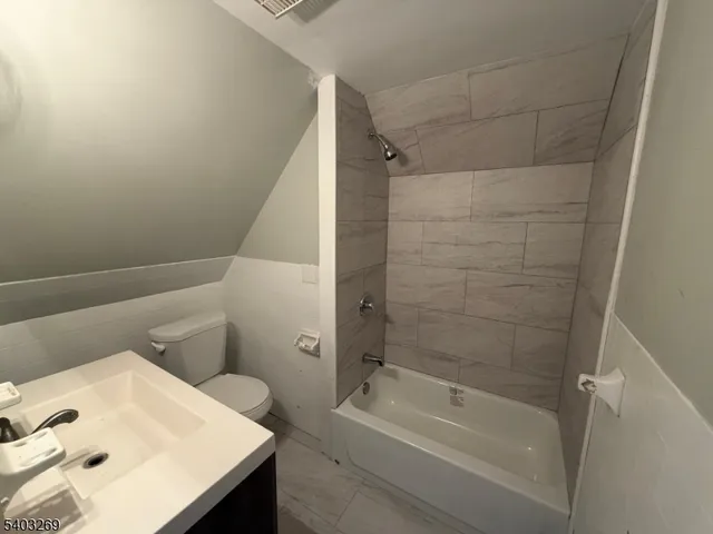 a bathroom with a bathtub and sink