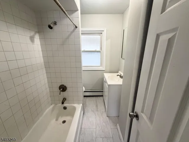 a bathroom with a bathtub a toilet and a shower