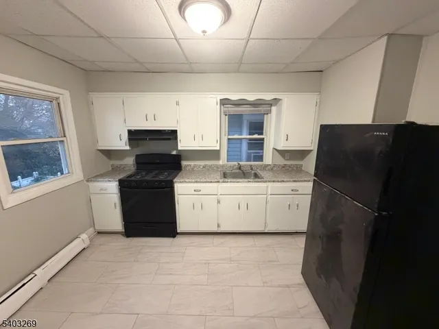 a kitchen with a refrigerator and a stove