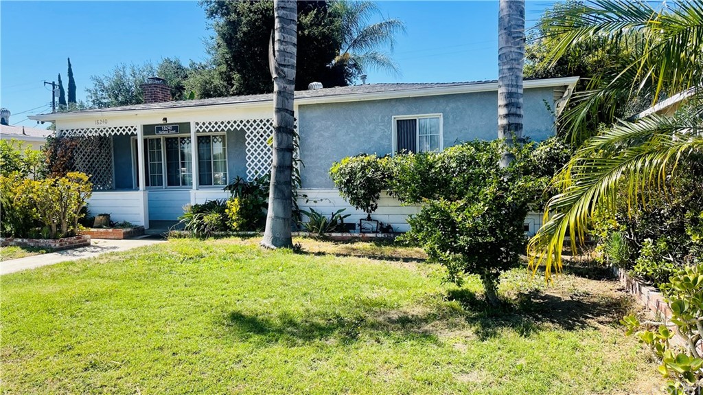 a view of a house with a yard and plants