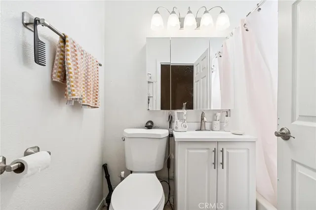 a bathroom with a sink and mirror with toilet