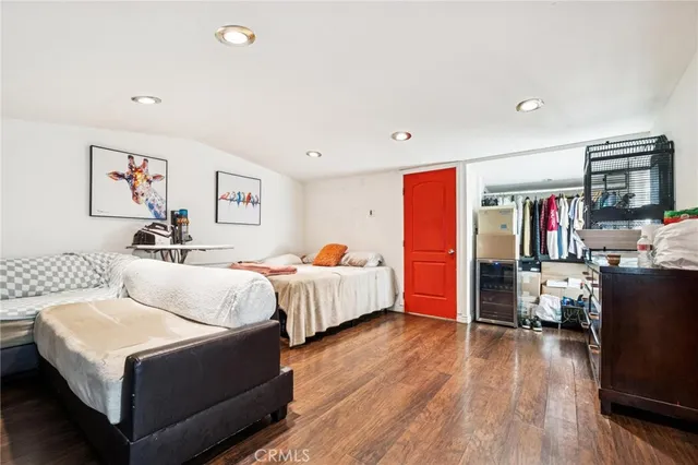 a bedroom with bed and wooden floor