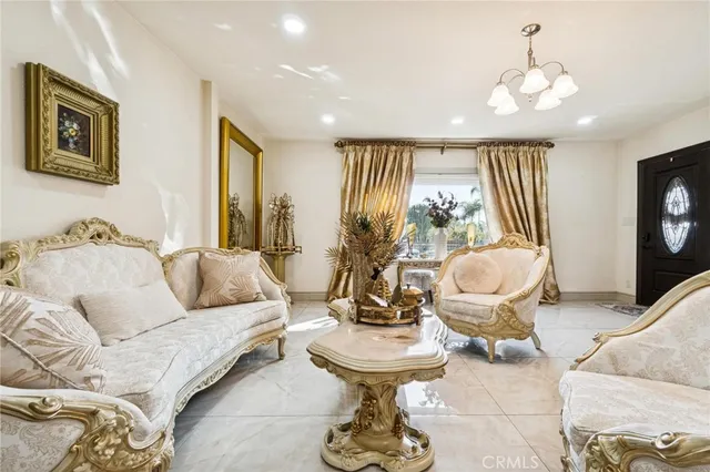 a living room with furniture and a chandelier