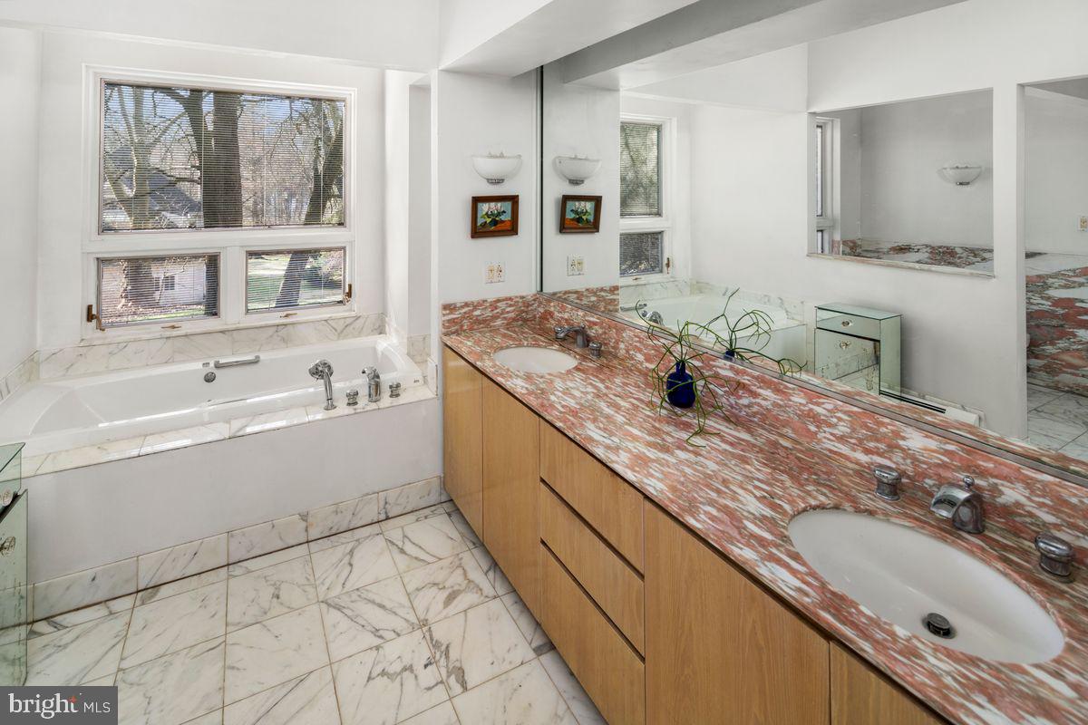 145 East Bells Mill Road Philadelphia, PA 19118 - Photo 26 of 38 a bathroom with a granite countertop sink mirror and double