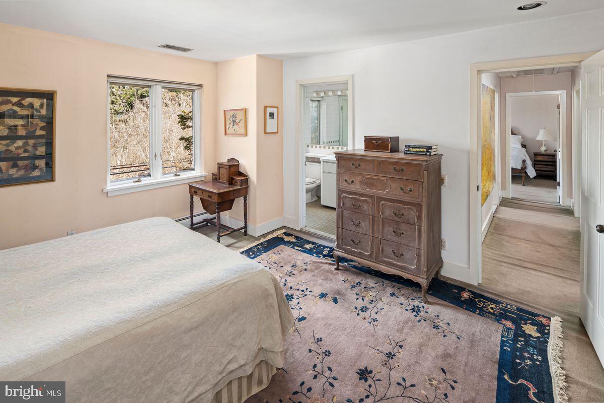 145 East Bells Mill Road Philadelphia, PA 19118 - Photo 28 of 38 a bedroom with a bed and wooden floor