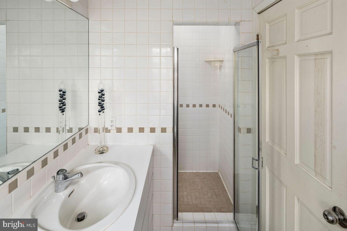145 East Bells Mill Road Philadelphia, PA 19118 - Photo 29 of 38 a bathroom with a tub sink and mirror