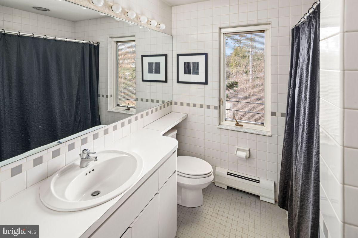 145 East Bells Mill Road Philadelphia, PA 19118 - Photo 31 of 38 a bathroom with a sink a toilet and a large mirror