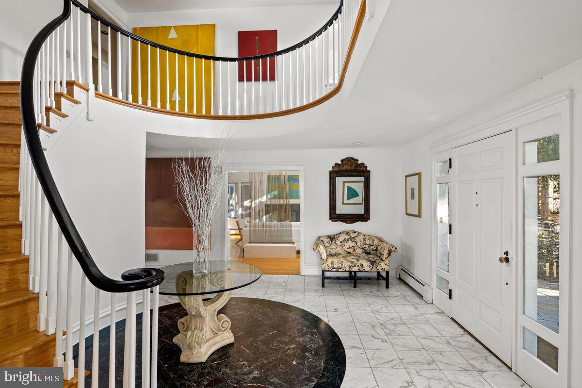 145 East Bells Mill Road Philadelphia, PA 19118 - Photo 4 of 38 a living room with furniture stairs and a chandelier