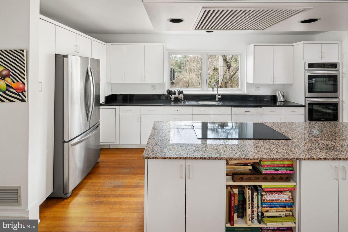 145 East Bells Mill Road Philadelphia, PA 19118 - Photo 8 of 38 a kitchen with stainless steel appliances granite countertop a sink and a refrigerator