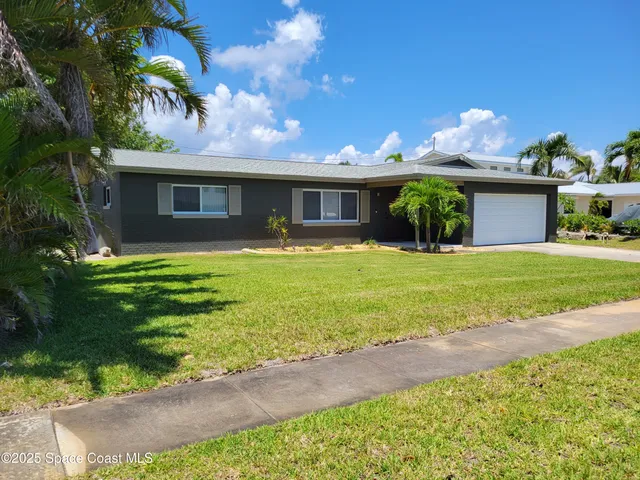 a front view of house with yard and outdoor seating