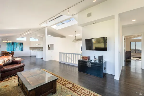 a large white kitchen with lots of counter space a sink and appliances