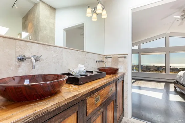 a bathroom with a granite countertop bathtub shower sink and mirror