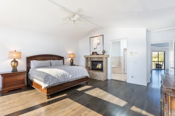 a spacious bedroom with a bed and a flat screen tv
