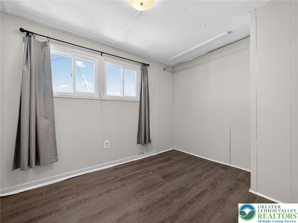 23 Roth Avenue Mertztown, PA 19539 - Photo 6 of 29 an empty room with wooden floor and a window