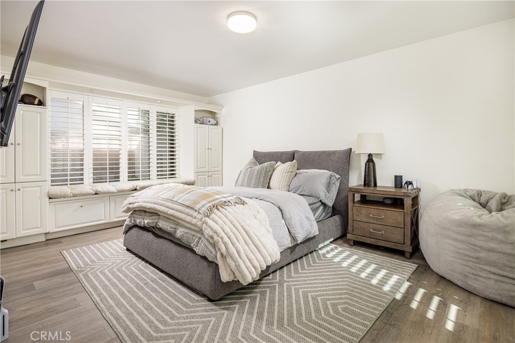 147 Monarch Bay Drive Dana Point, CA 92629 - Photo 8 of 18 a spacious bedroom with a bed and wooden floor