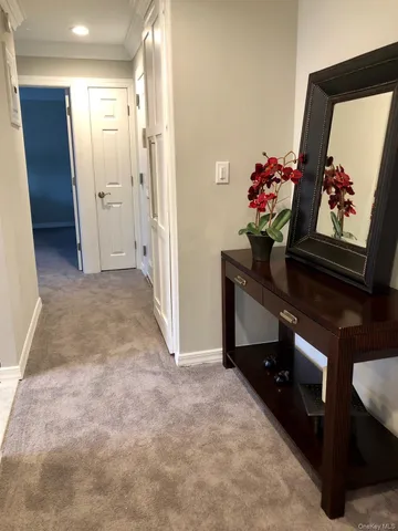 a view of hallway with wooden floor and stairs