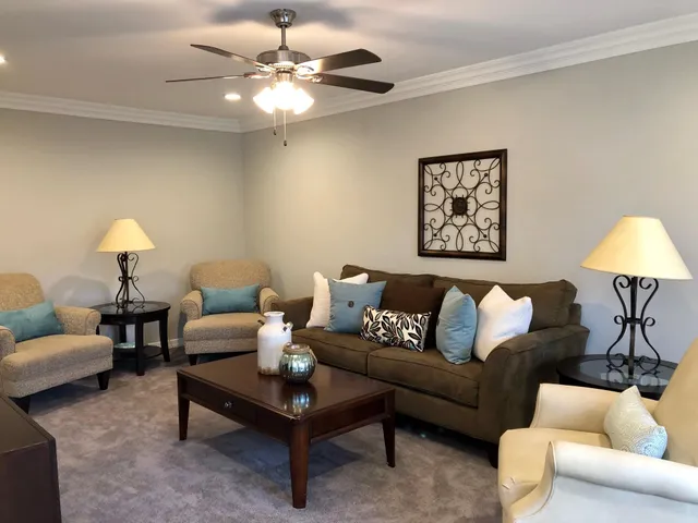 a living room with furniture and a chandelier