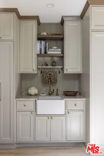 a living room with furniture and a book shelf