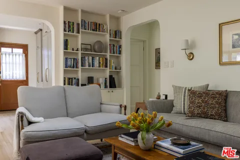 a shelf with books and knick knacks on a bookshelf