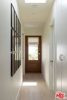 a large bed sitting in a bedroom next to a window