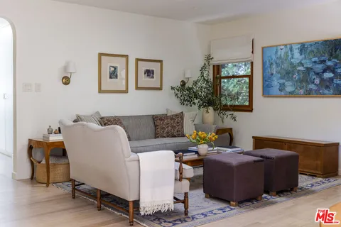 a living room with furniture and a potted plant