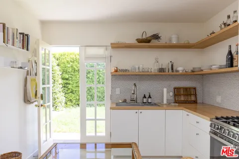 a bedroom with bed and a painting on the wall