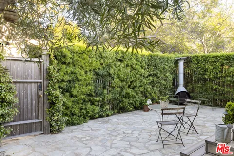 a view of a chair and table in the backyard