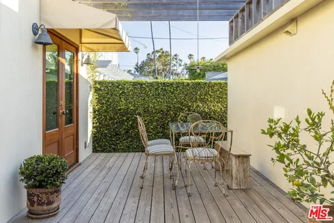 a view of a patio with table and chairs and potted plants