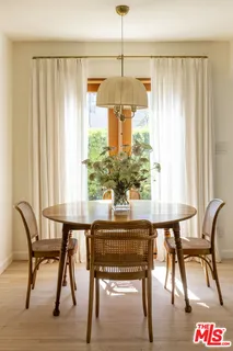 a dining room table chairs and a chandelier