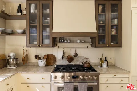 a kitchen with a stove and cabinets