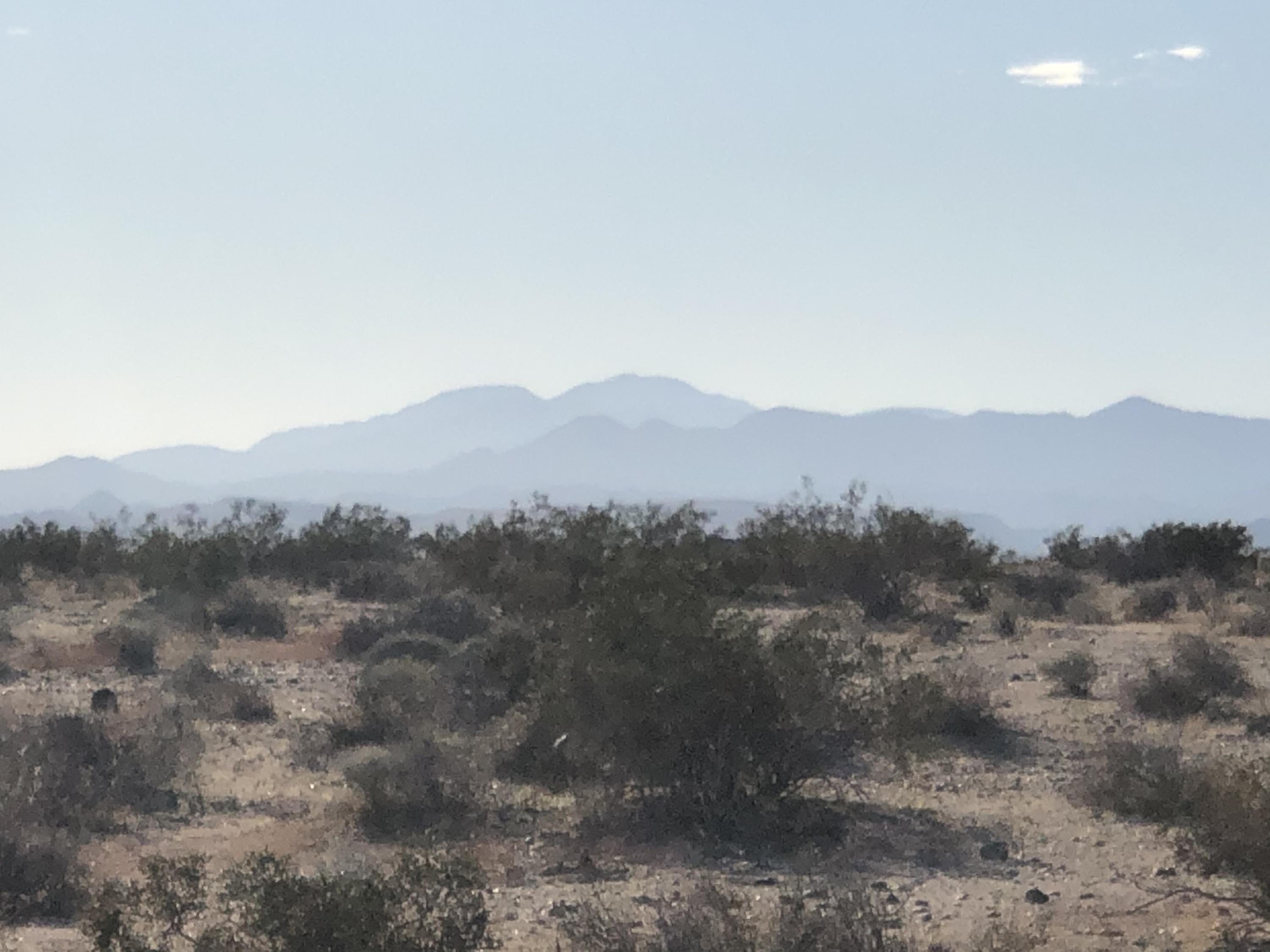 65995 Sonora Road Joshua Tree, CA 92252 - Photo 14 of 18 a view of a mountain in the distance in a field
