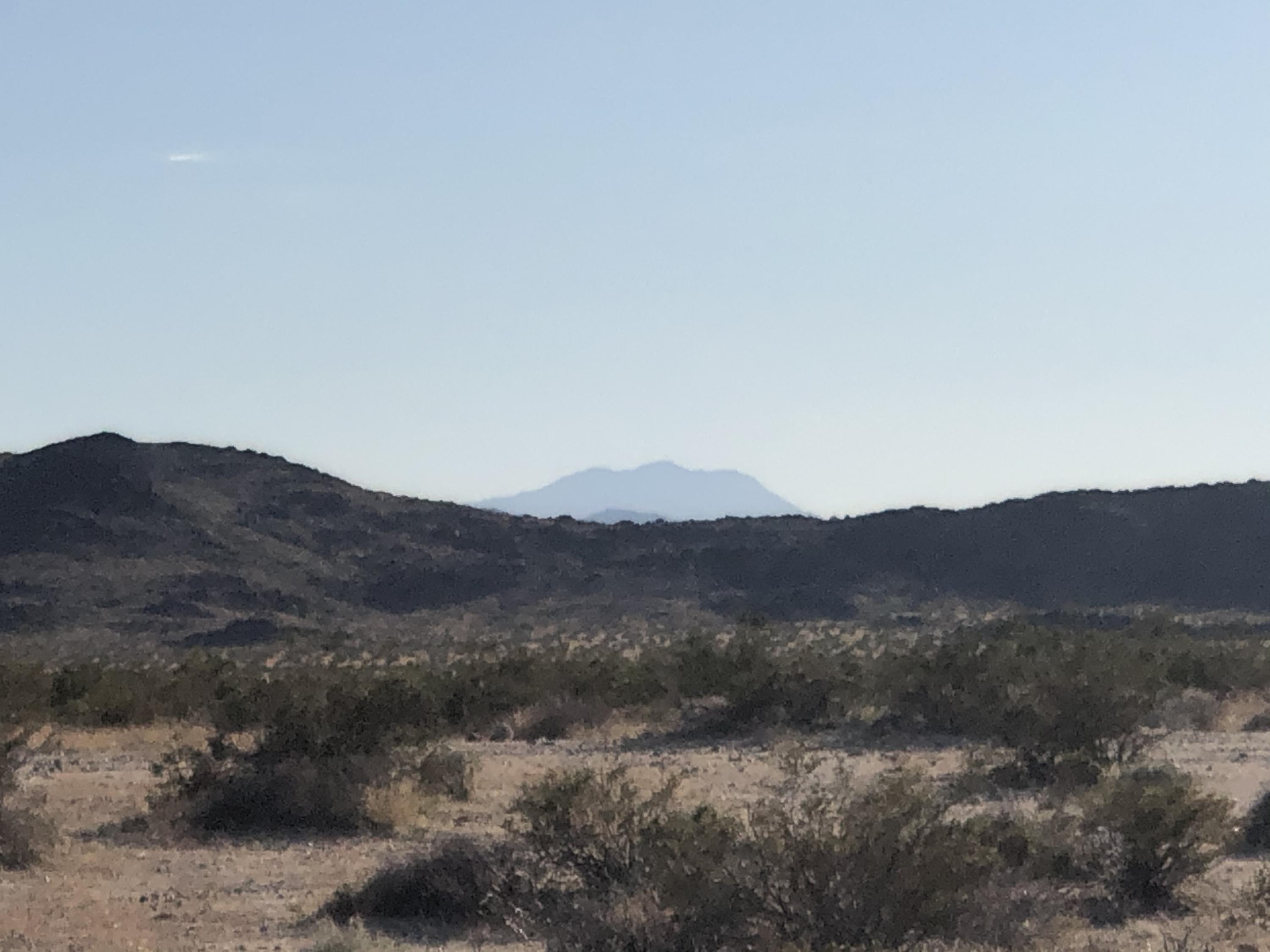 65995 Sonora Road Joshua Tree, CA 92252 - Photo 15 of 18 a view of a mountain range with a lush green hillside