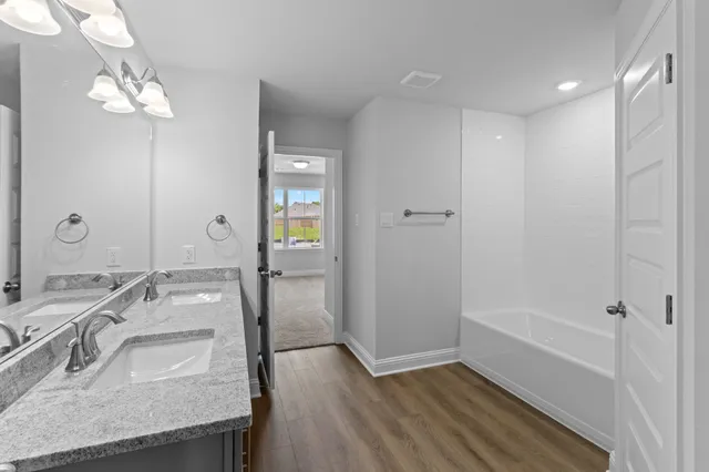 a bathroom with a granite countertop sink a large mirror and a