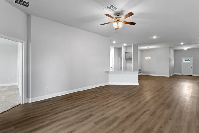 a view of kitchen with wooden floor and electronic appliances