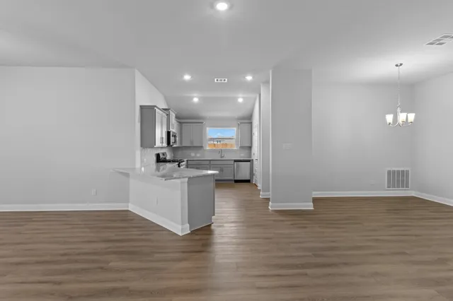 a view of kitchen with stove and wooden floor