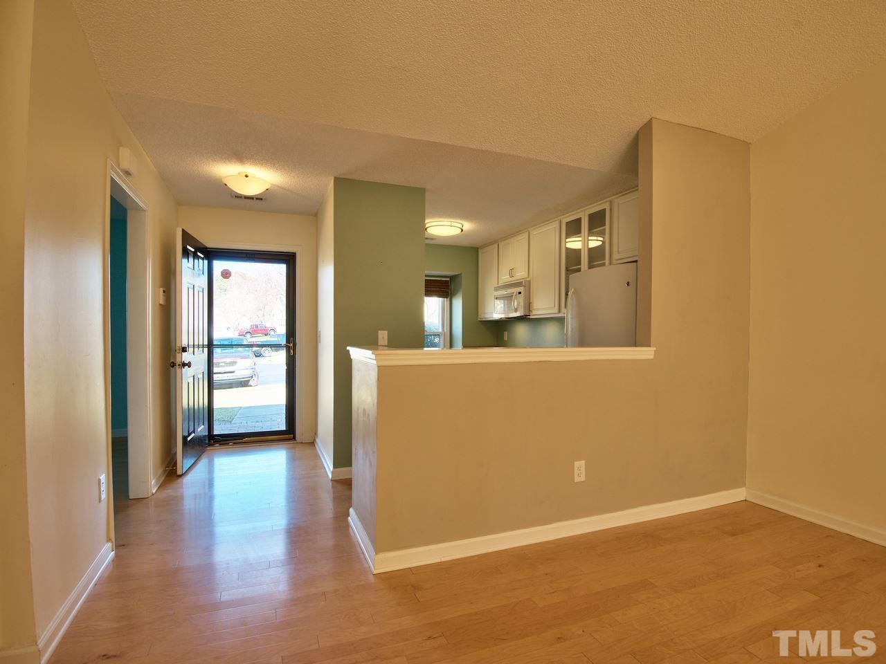 2740 Cottage Circle Raleigh, NC 27613 - Photo 2 of 25 a view of a big room with wooden floor and a kitchen