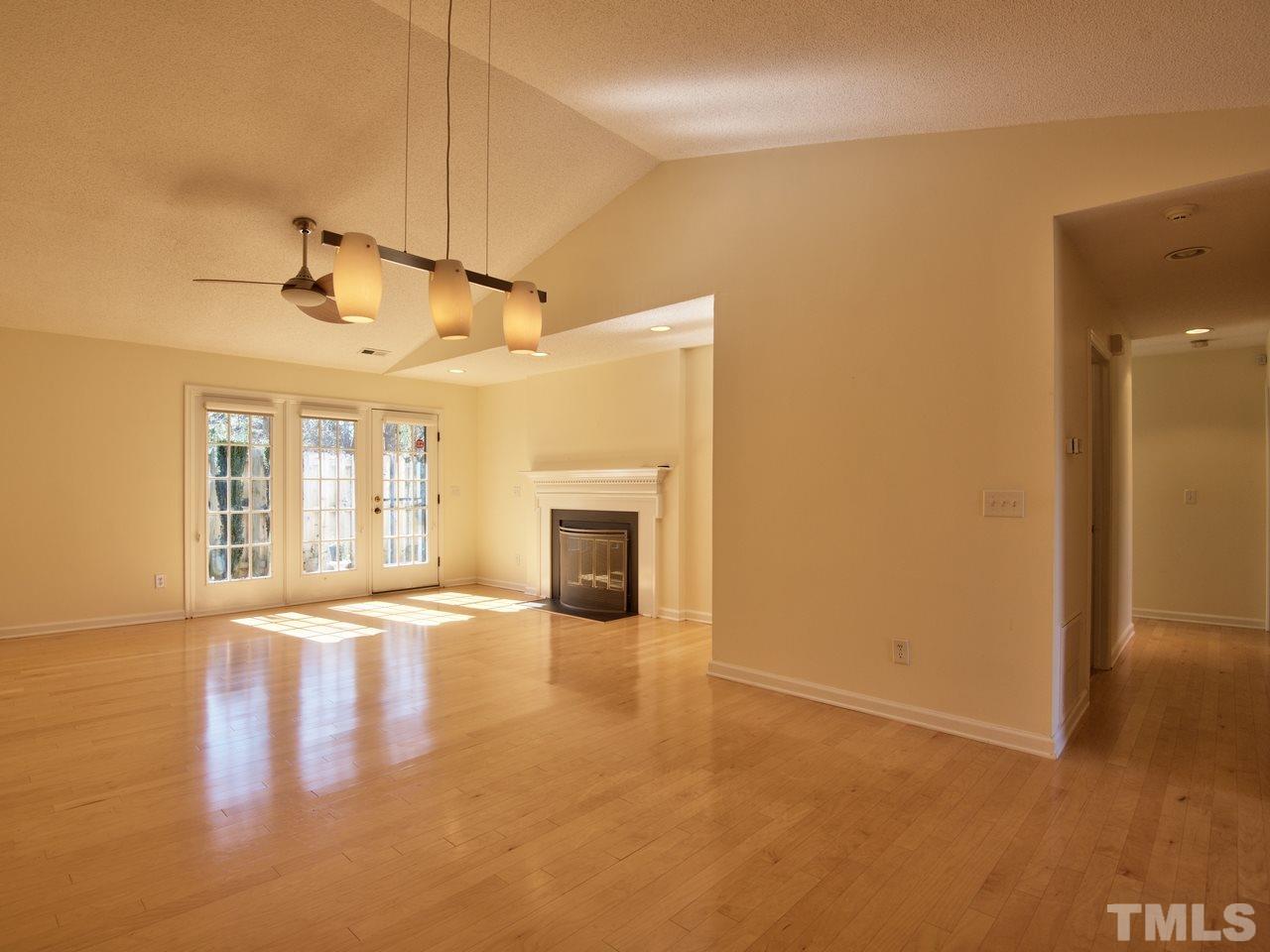 2740 Cottage Circle Raleigh, NC 27613 - Photo 12 of 25 a view of an empty room with window and wooden floor