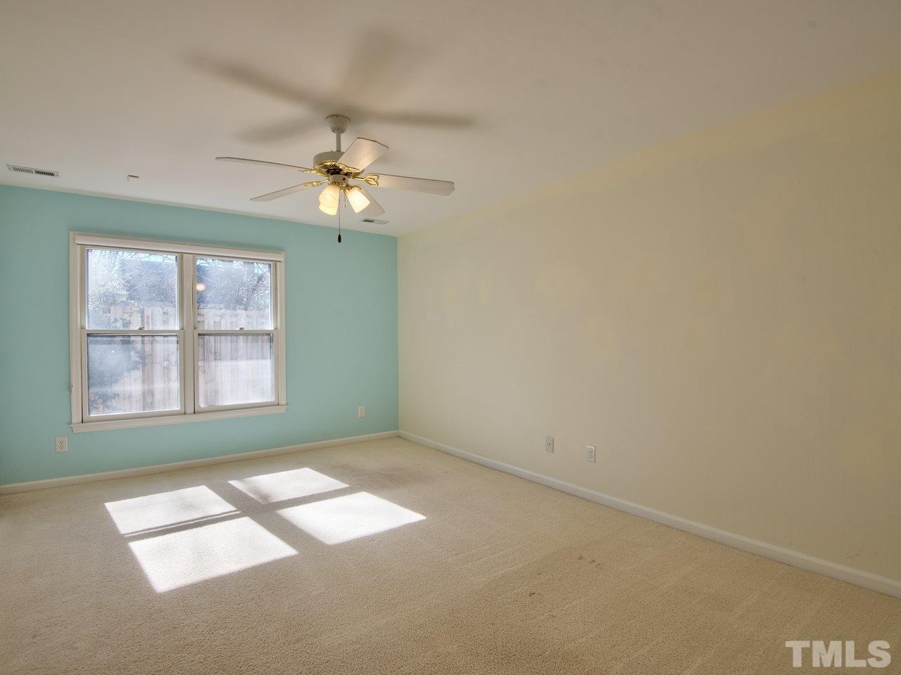 2740 Cottage Circle Raleigh, NC 27613 - Photo 15 of 25 an empty room with windows and fan