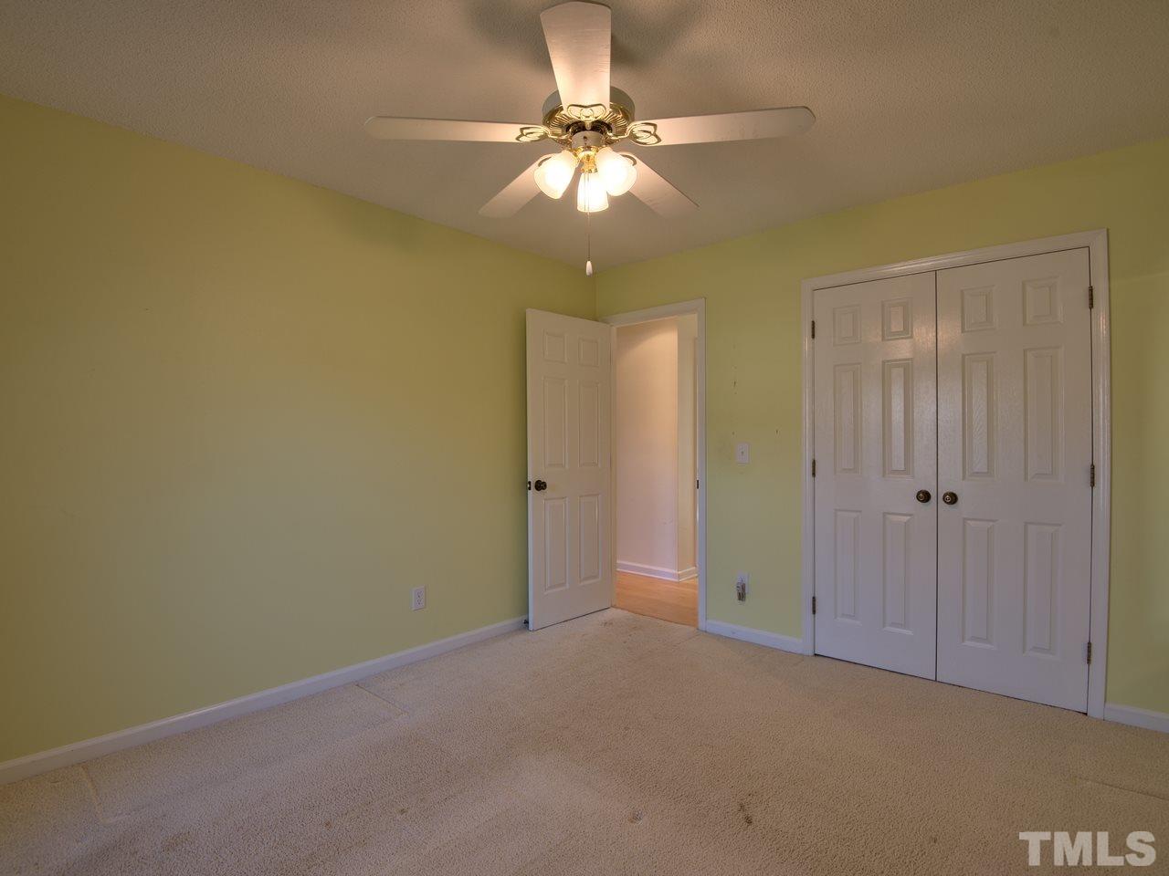 2740 Cottage Circle Raleigh, NC 27613 - Photo 18 of 25 a view of an empty room and chandelier fan