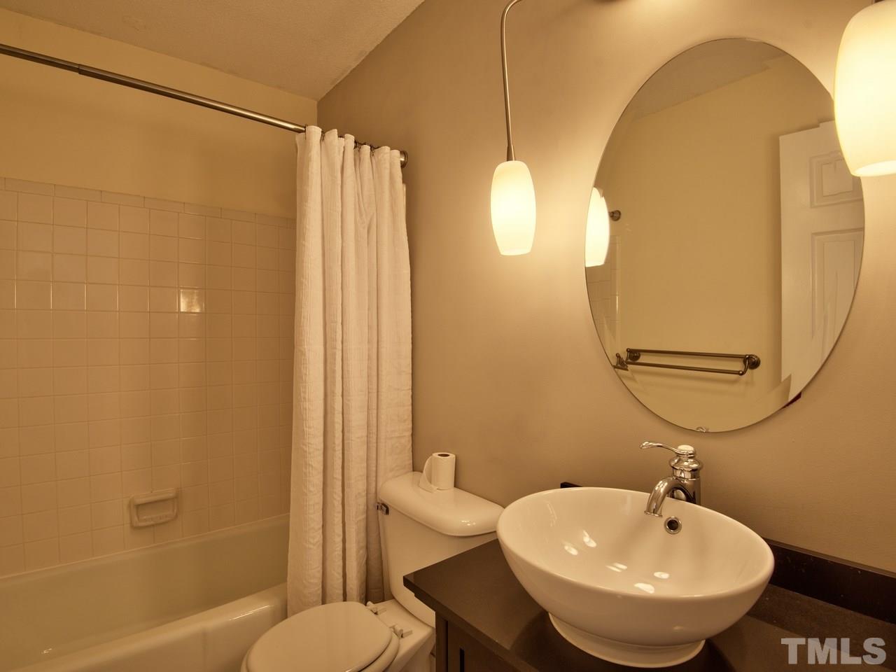 2740 Cottage Circle Raleigh, NC 27613 - Photo 19 of 25 a bathroom with a sink a toilet and shower
