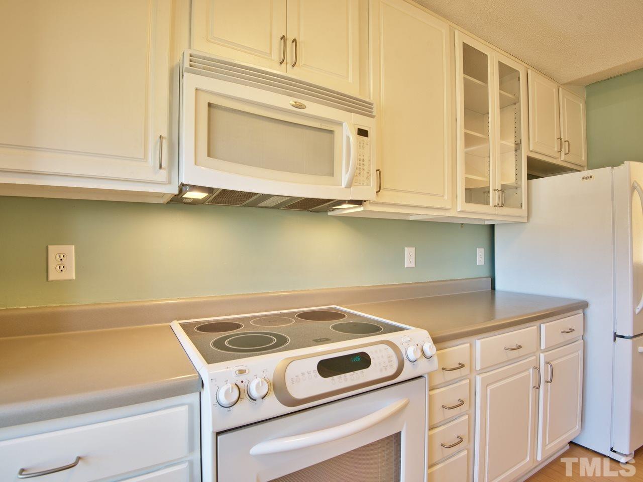 2740 Cottage Circle Raleigh, NC 27613 - Photo 5 of 25 a kitchen with granite countertop cabinets appliances and a counter top
