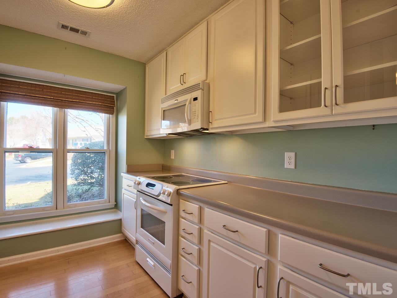 2740 Cottage Circle Raleigh, NC 27613 - Photo 7 of 25 a kitchen with stainless steel appliances granite countertop a sink and a granite counter tops