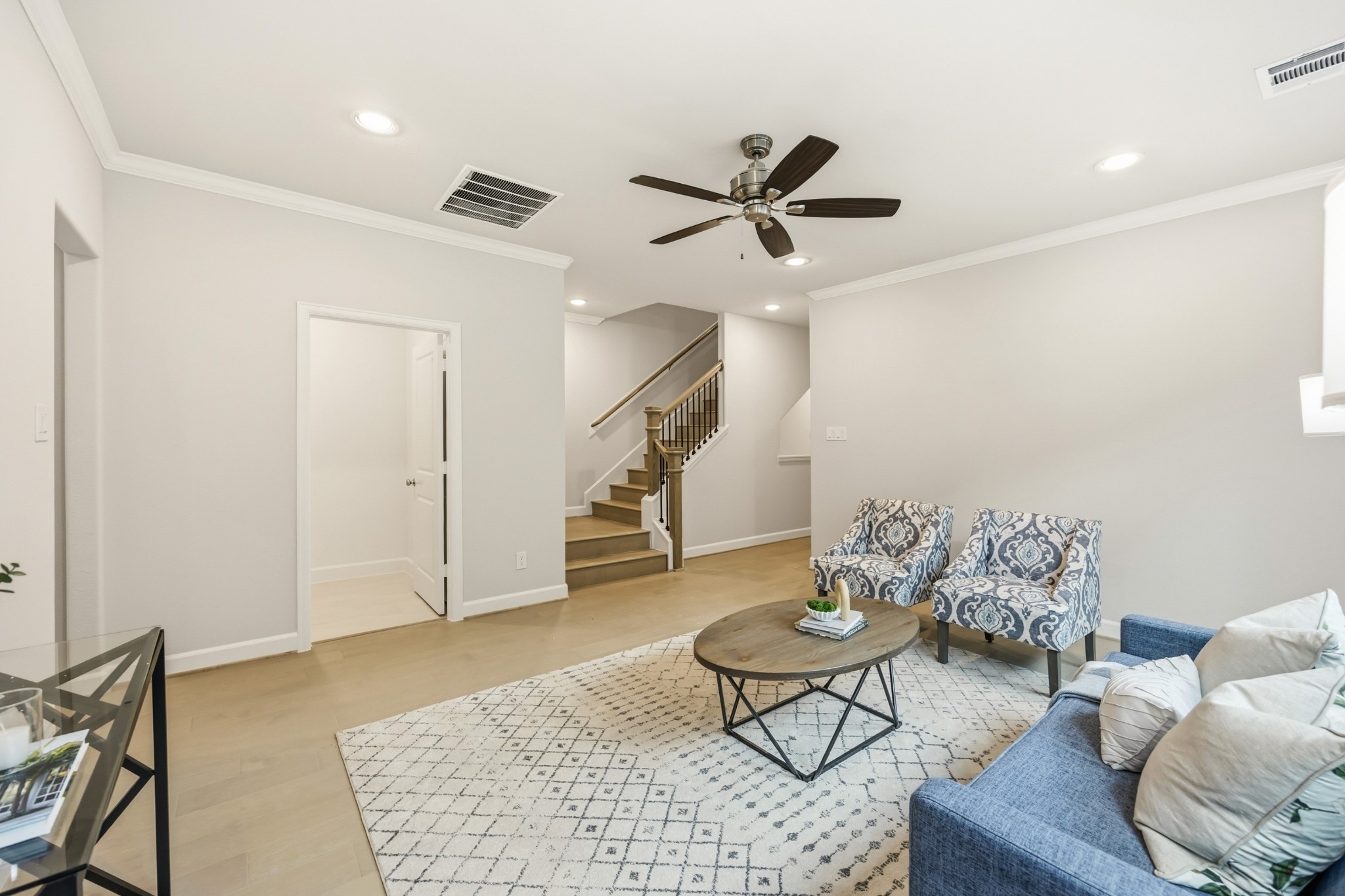 4317 Roseland Street, Unit B Houston, TX 77006 - Photo 15 of 29 An alternate view of the game room shows a ceiling fan, access to the third level, and a journey down to the laundry room, defining multifunctional luxury.