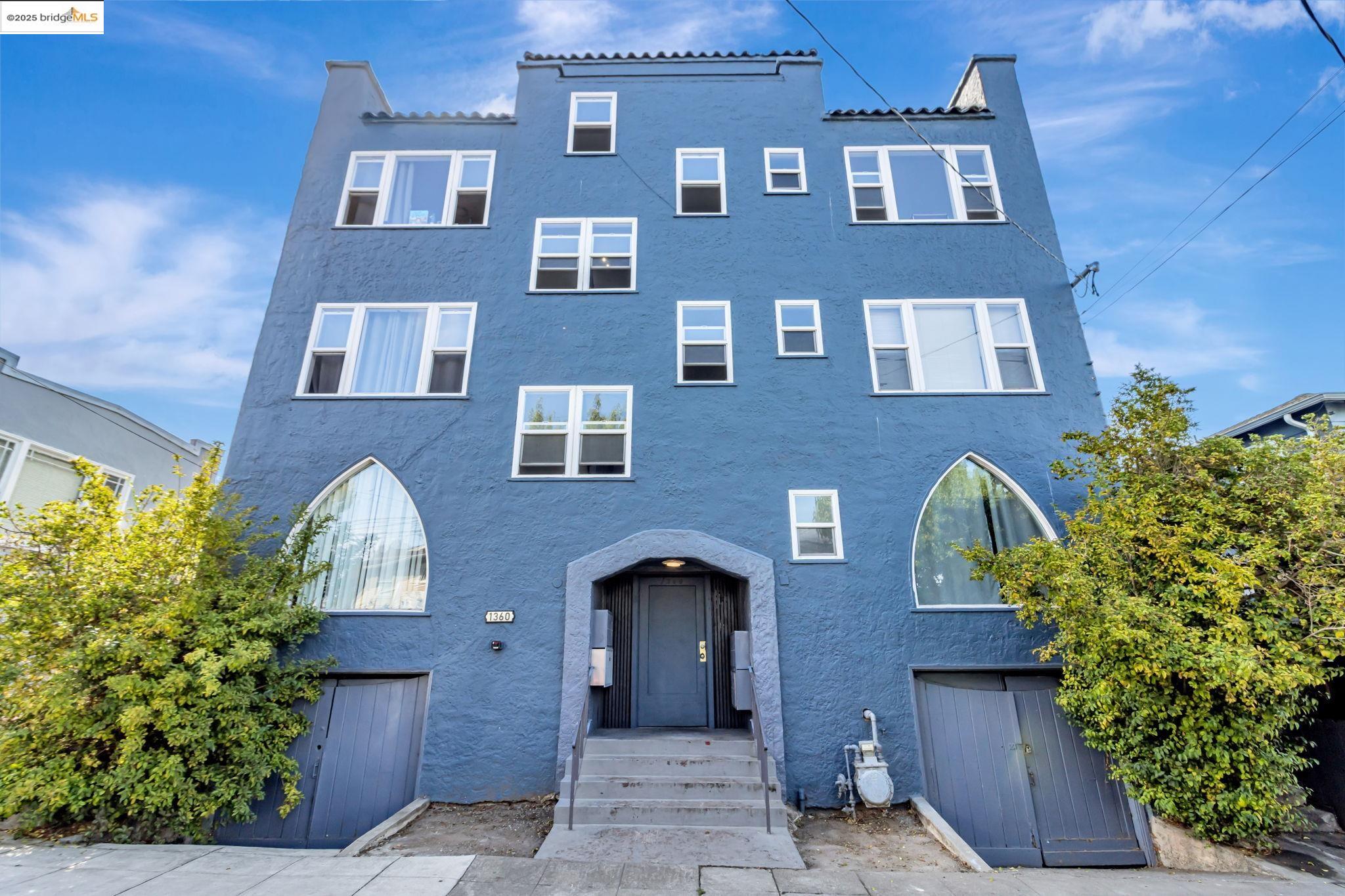 1360 Berkeley Way Berkeley, CA 94702 - Photo 1 of 35 a front view of a multi story residential apartment building with a yard and potted plants