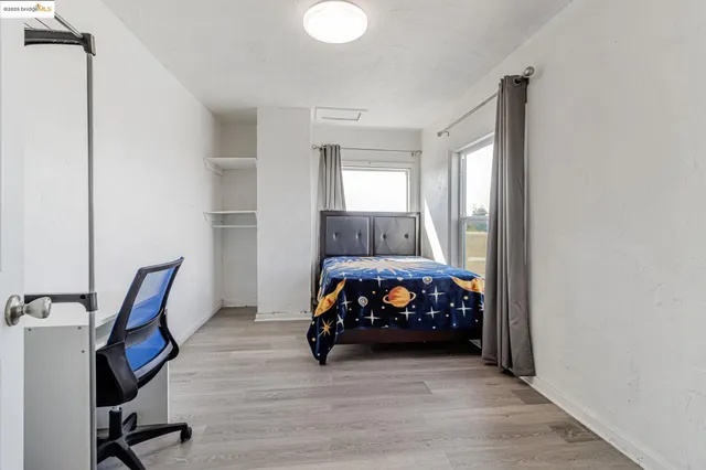 a bedroom with furniture and a window