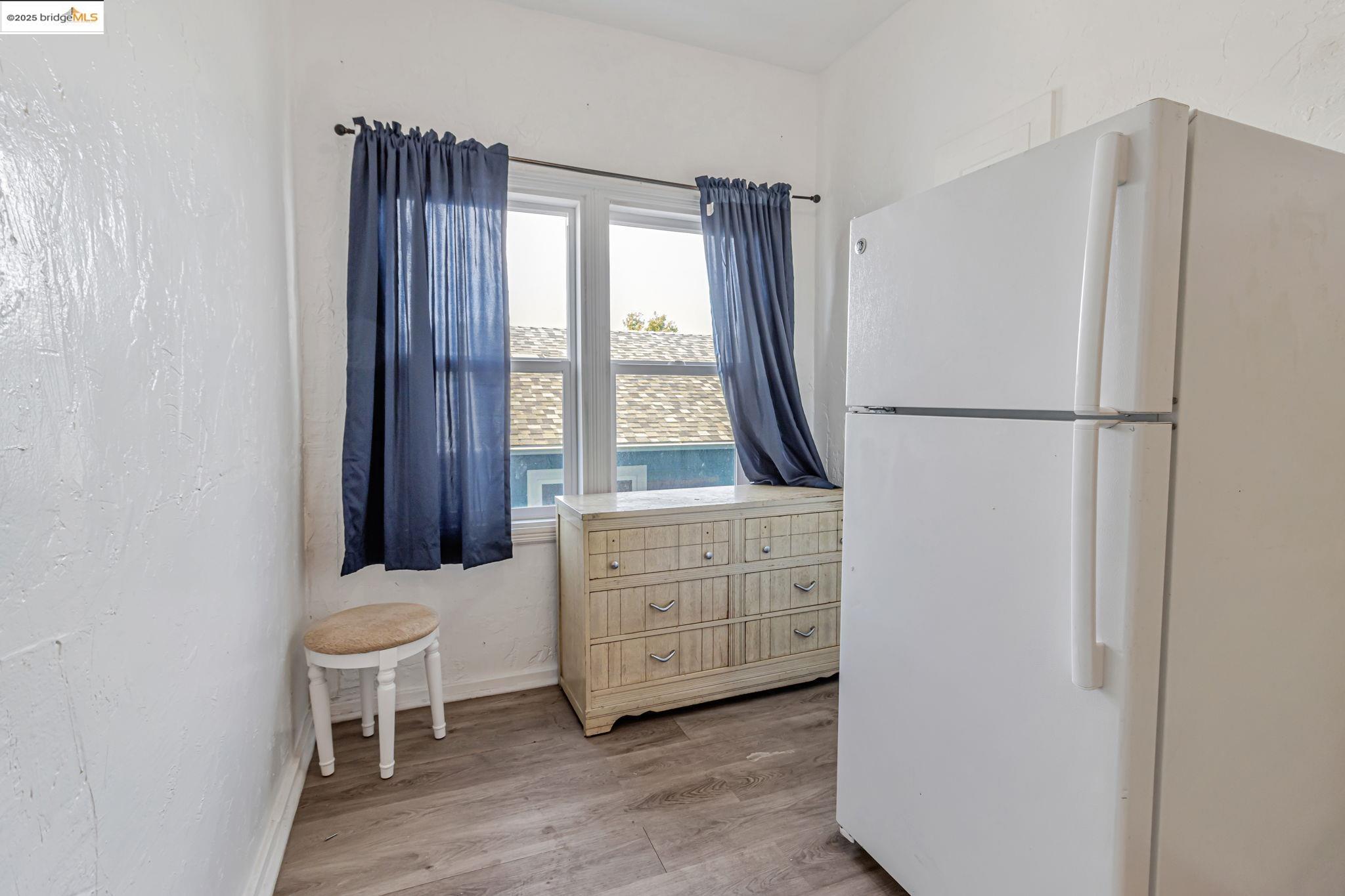1360 Berkeley Way Berkeley, CA 94702 - Photo 21 of 35 a kitchen with white cabinets and white appliances