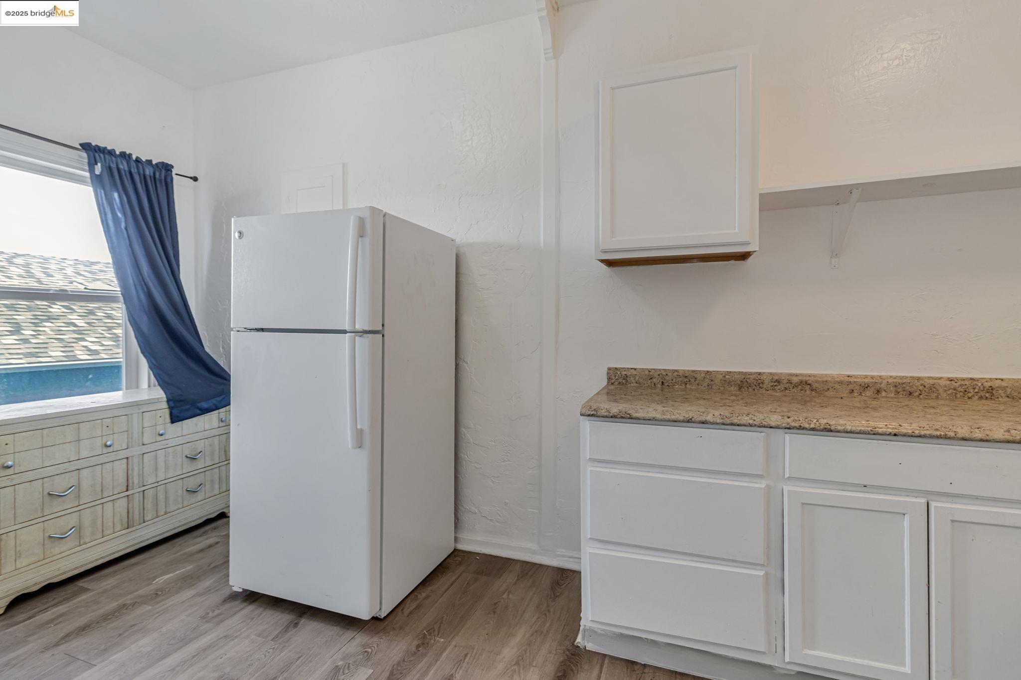1360 Berkeley Way Berkeley, CA 94702 - Photo 23 of 35 a kitchen with granite countertop white cabinets and white appliances