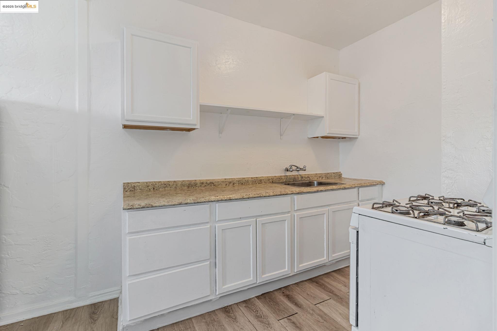 1360 Berkeley Way Berkeley, CA 94702 - Photo 24 of 35 a kitchen with granite countertop a sink and a stove