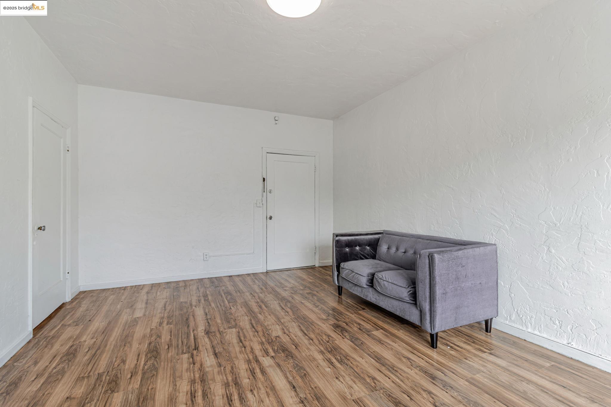 1360 Berkeley Way Berkeley, CA 94702 - Photo 25 of 35 a living room with furniture and a wooden floor