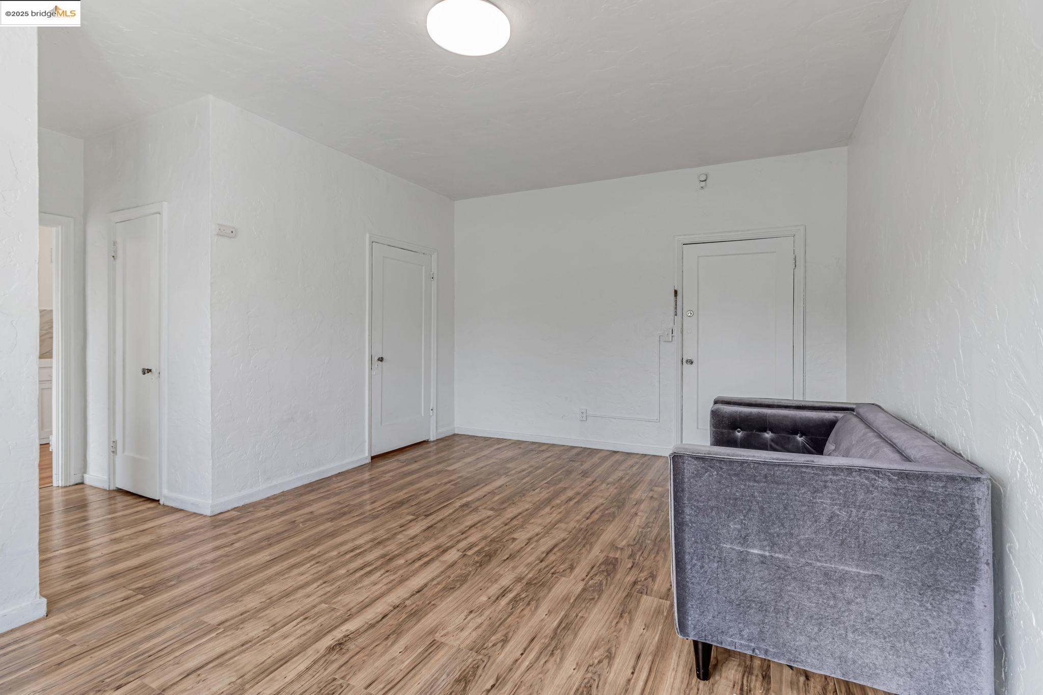 1360 Berkeley Way Berkeley, CA 94702 - Photo 26 of 35 a bedroom with a bed and a wooden floor